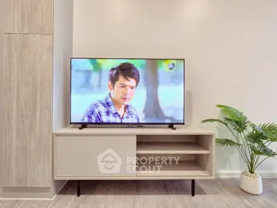 Modern living room with stylish TV stand and indoor plant