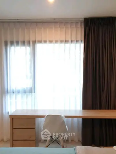 Modern study area with wooden desk and elegant curtains