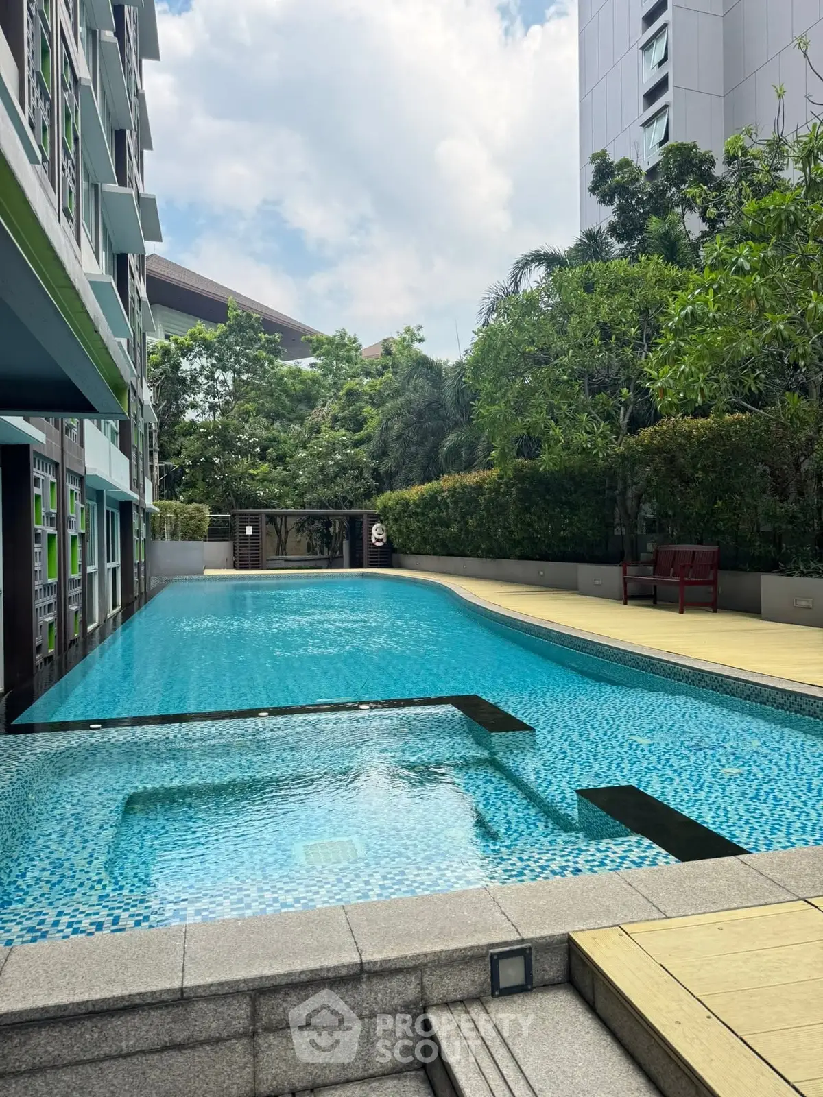 Luxurious residential pool area with modern design and lush greenery, perfect for relaxation and leisure.