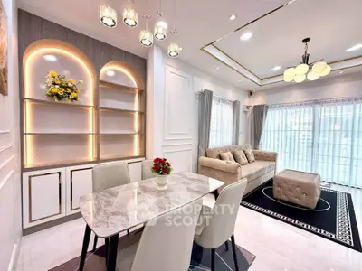 Elegant living room with modern decor, featuring a cozy sofa, stylish dining area, and ambient lighting.