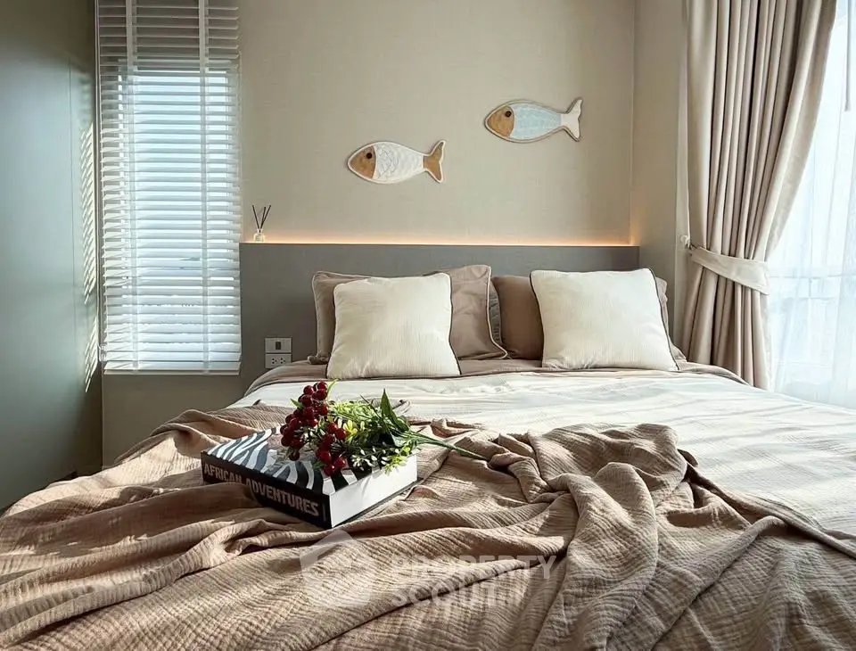 Cozy bedroom with stylish decor and natural light, perfect for relaxation.
