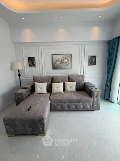 Elegant living room with modern gray sectional sofa and stylish decor, perfect for contemporary living.