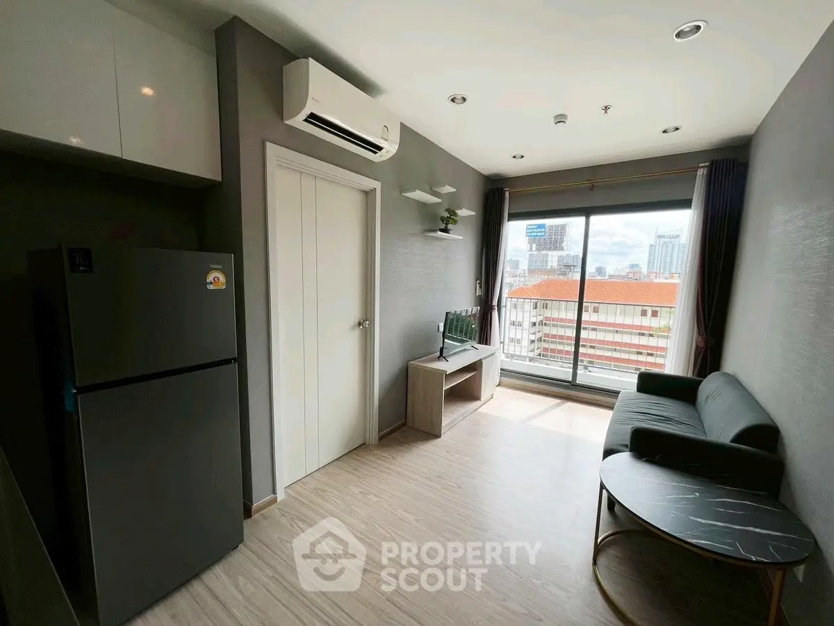 Modern living room with city view, sleek furniture, and natural light.