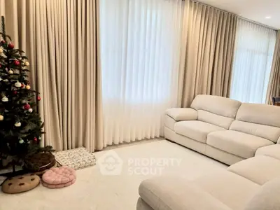 Spacious living room with elegant curtains and cozy seating