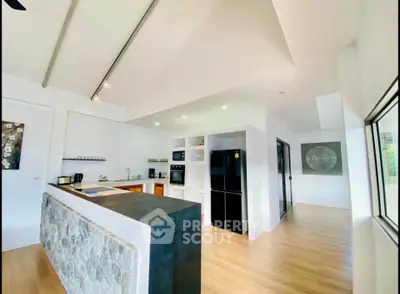 Modern kitchen with sleek design, featuring open layout and high-end appliances in a bright, airy space.
