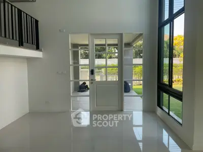 Spacious modern living room with large windows and garden view
