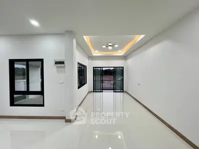 Spacious modern living room with glossy floors and recessed lighting