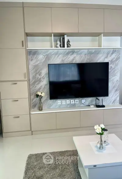 Modern living room with sleek built-in entertainment center and stylish decor