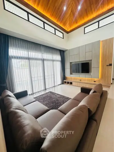 Luxurious modern living room with high ceilings and elegant lighting