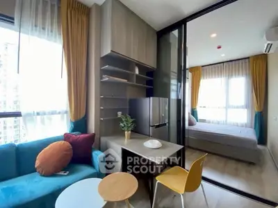 Modern apartment interior with cozy living room and bedroom, featuring stylish furniture and large windows.