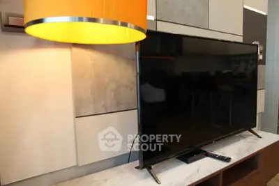 Modern living room with sleek TV and stylish lighting