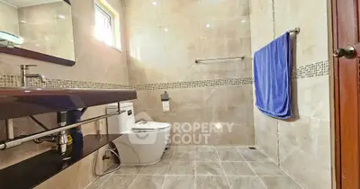 Spacious modern bathroom with elegant fixtures and natural light