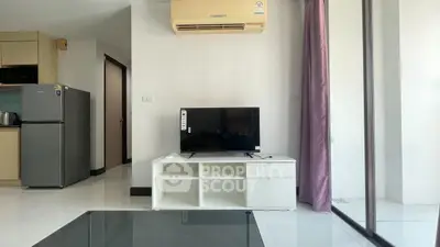 Modern living room with sleek TV unit, air conditioning, and glass door leading to balcony.