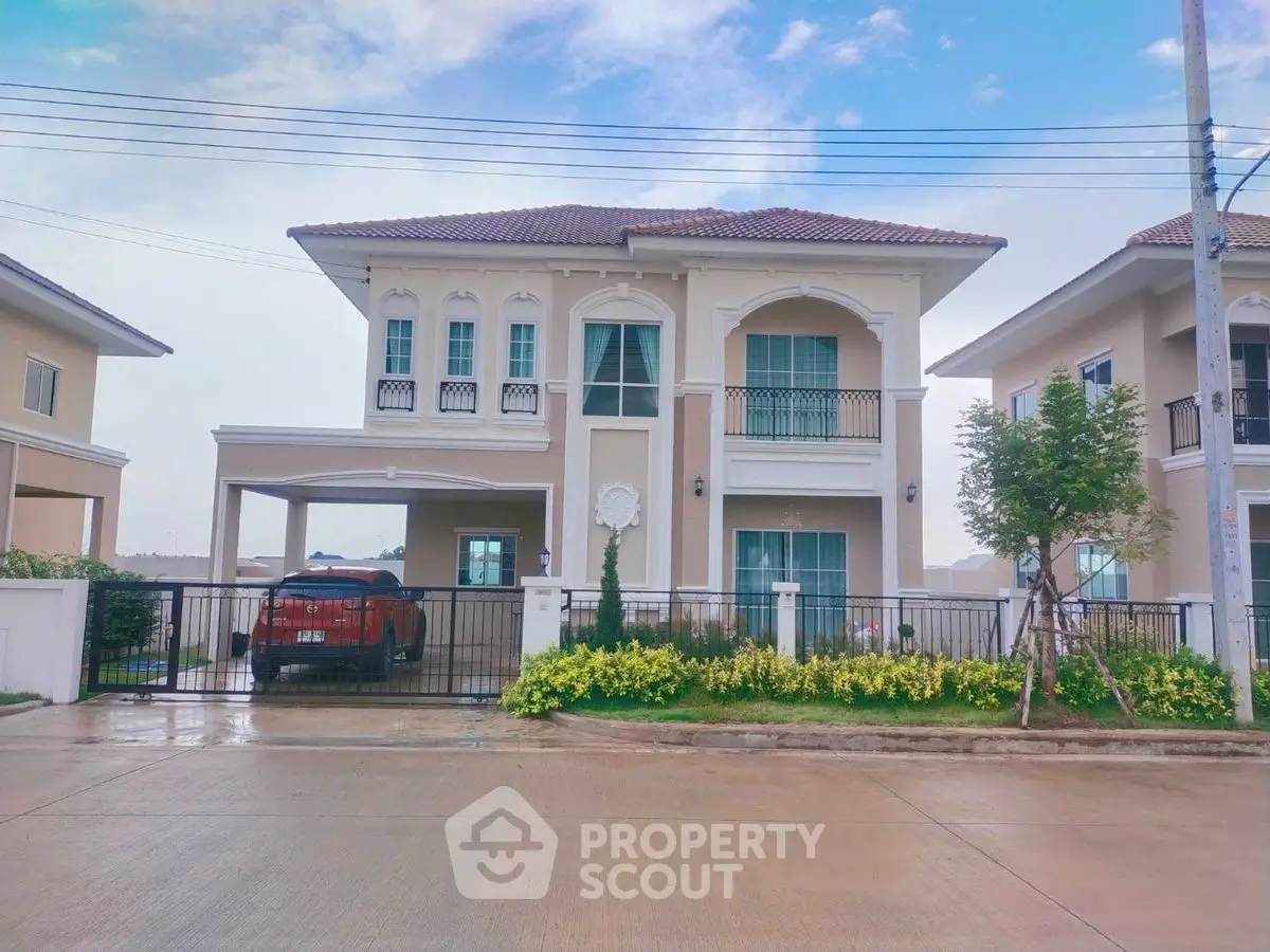 Elegant two-story house with manicured garden and spacious driveway in suburban neighborhood.