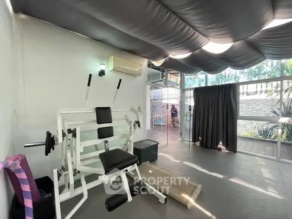 Spacious home gym with modern equipment and natural light