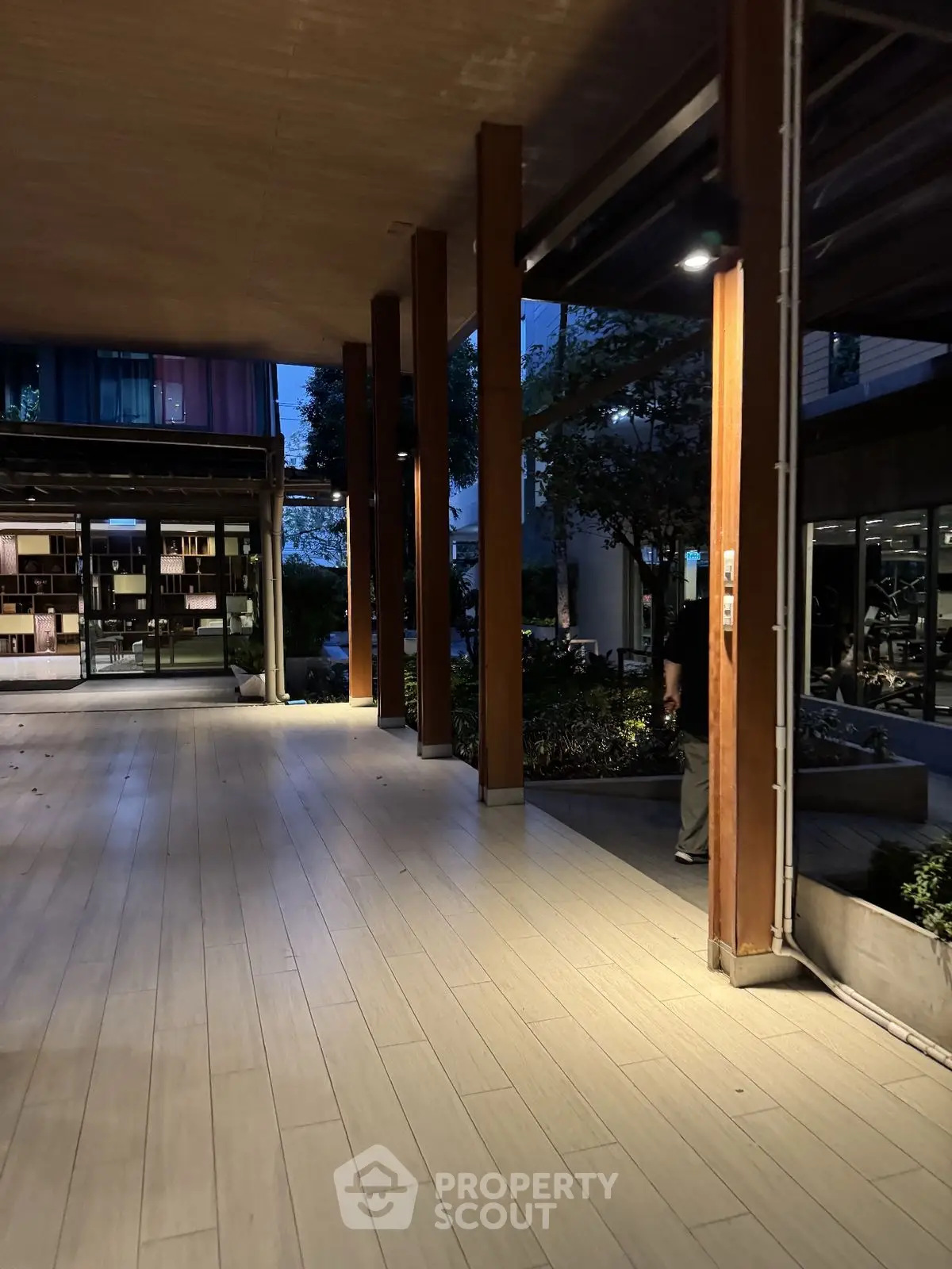 Modern building entrance with wooden pillars and sleek design