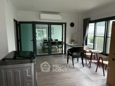 Spacious living room with modern decor and large windows offering natural light.