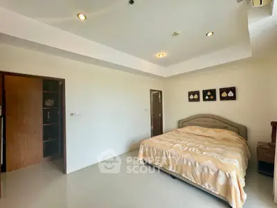 Spacious bedroom with modern decor and cozy ambiance