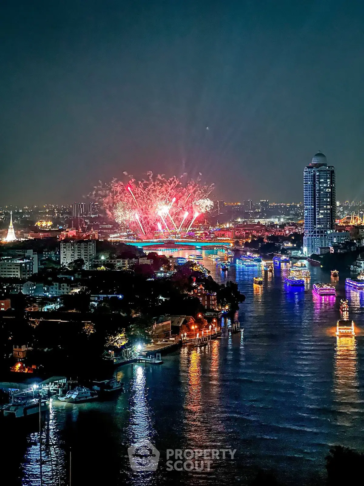Stunning riverfront cityscape with vibrant fireworks display at night