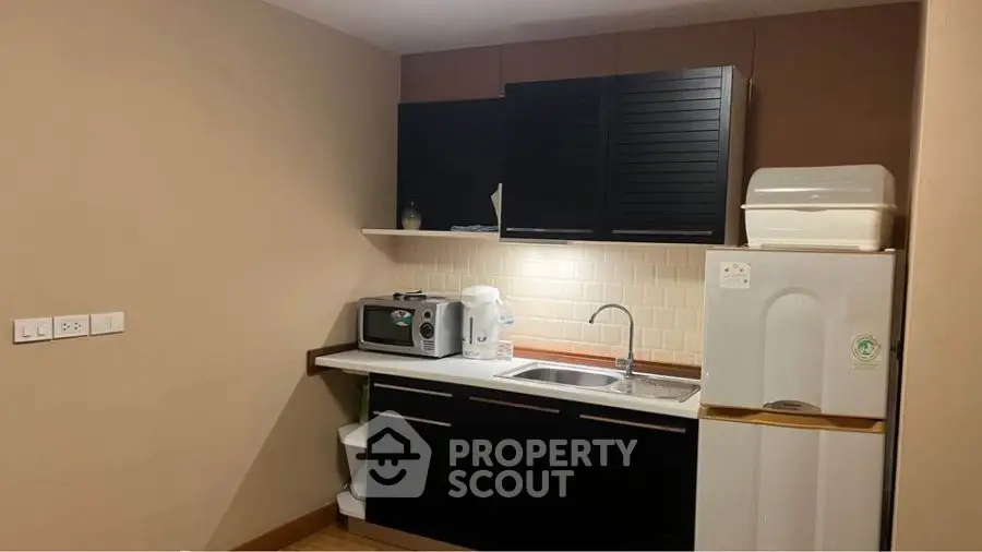 Cozy kitchen with modern appliances and sleek cabinetry in a compact layout.