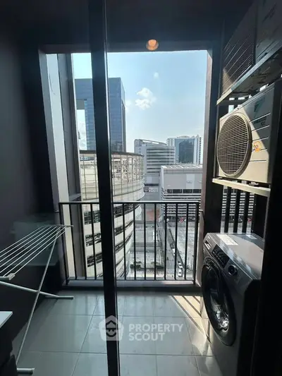 Urban apartment balcony with laundry area and city view