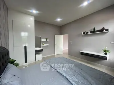 Modern bedroom with sleek design, featuring built-in wardrobe and stylish decor.