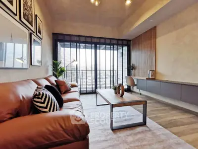 Modern living room with leather sofa and city view balcony, perfect for urban lifestyle.