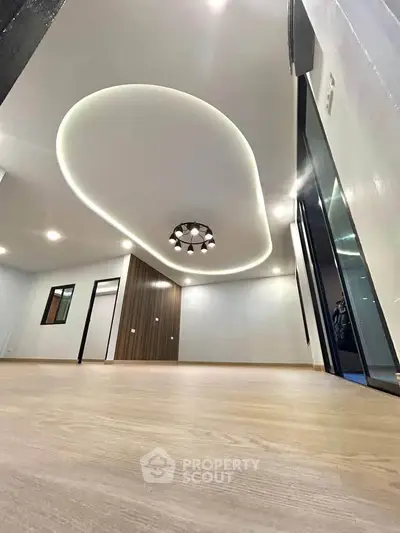 Modern living room with unique ceiling design and wooden flooring