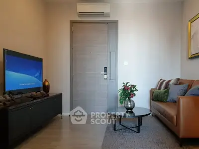 Modern living room with sleek furniture and wall-mounted TV, featuring a cozy ambiance.