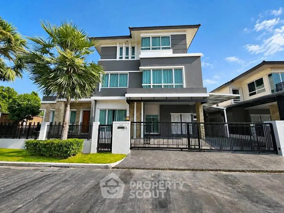 Stunning modern three-story house with sleek design and lush landscaping, perfect for luxurious living.