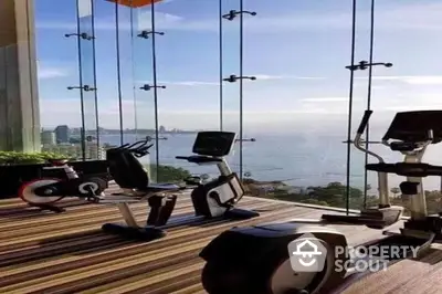 Luxury gym with panoramic ocean view and modern exercise equipment