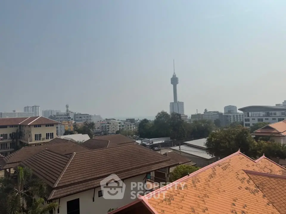 Stunning cityscape view with iconic tower and rooftops, perfect for urban living enthusiasts.