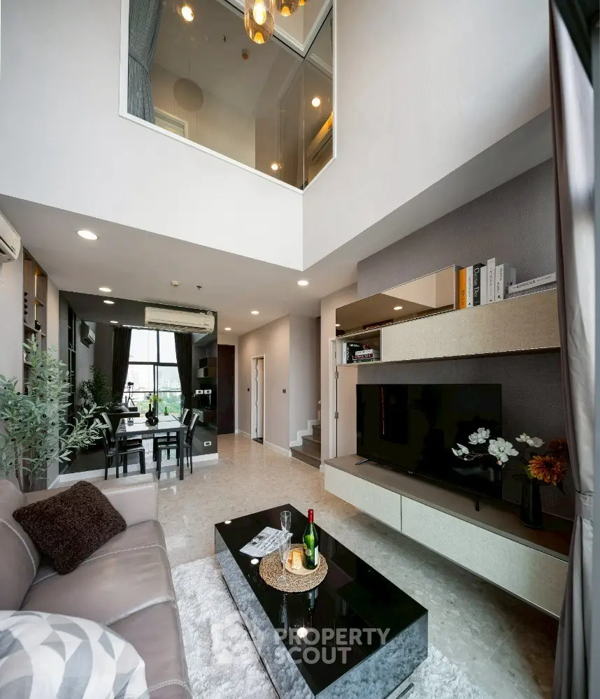 Luxurious modern living room with high ceiling and elegant decor