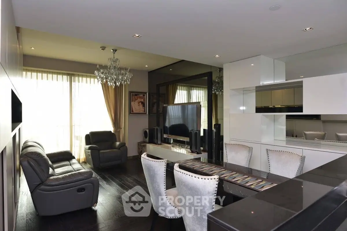 Luxurious modern living room with elegant decor and large TV, perfect for relaxation and entertainment.