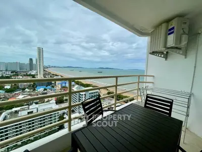 Stunning balcony view of city skyline and ocean, perfect for relaxation.