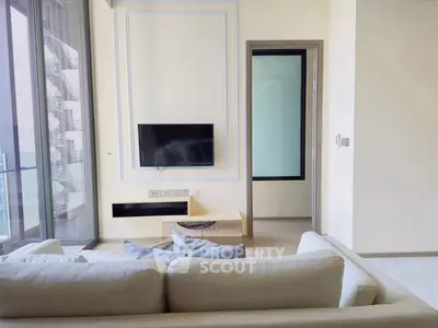 Modern living room with sleek TV setup and large window view