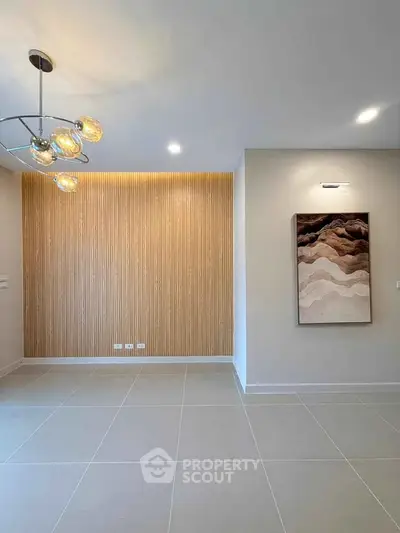 Modern minimalist interior with stylish lighting and textured wall paneling.