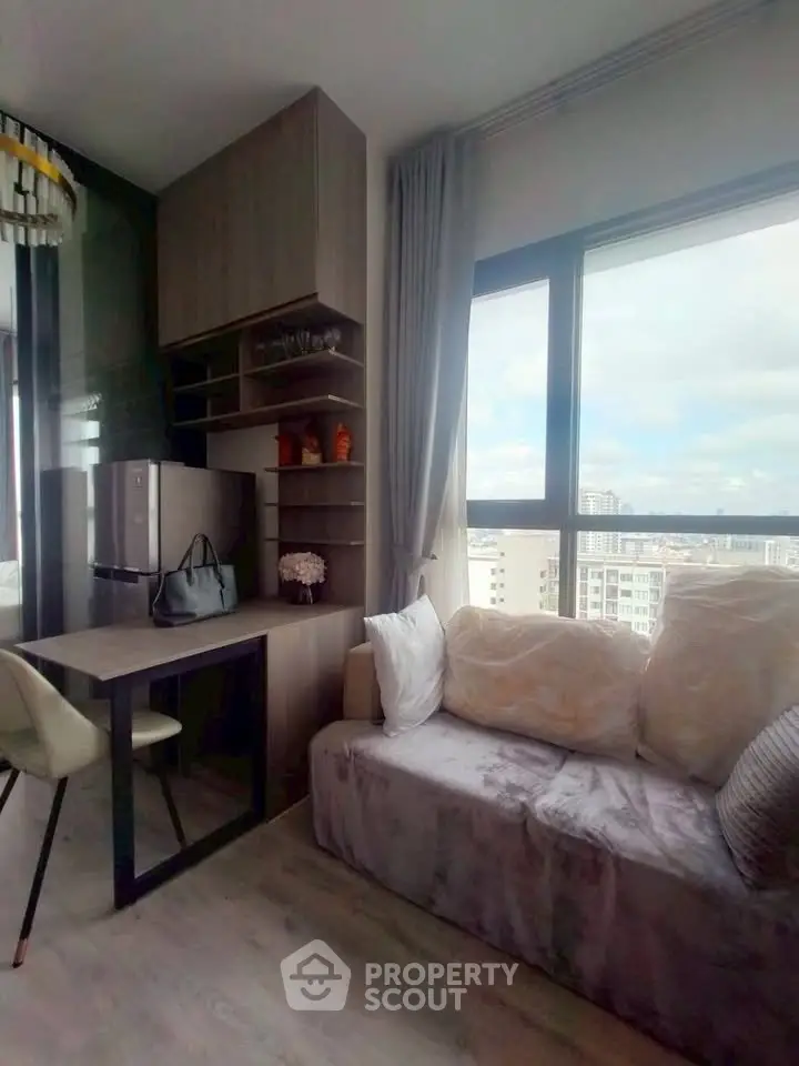 Modern living room with city view, cozy sofa, and compact dining area