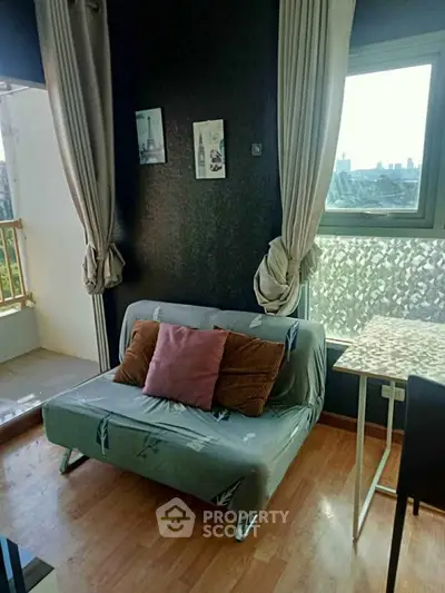 Cozy living room with stylish decor and balcony view, perfect for urban living.