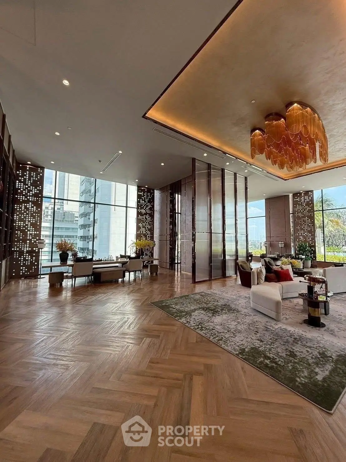 Luxurious modern living room with elegant decor and large windows offering stunning city views.