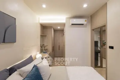 Modern bedroom with sleek design and air conditioning, featuring cozy bedding and ambient lighting.