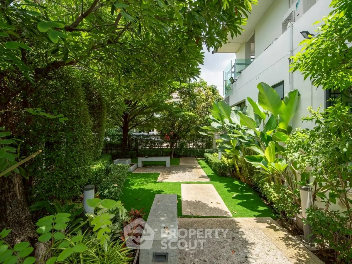 Lush garden oasis with modern landscaping and seating area in a serene residential setting.