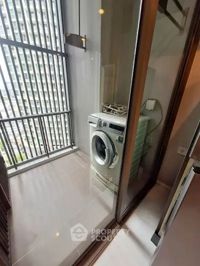 Modern apartment balcony with washing machine and city view
