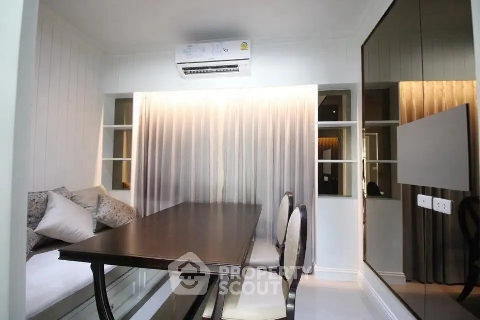 Cozy dining area with elegant table and chairs, complemented by soft lighting and modern decor.