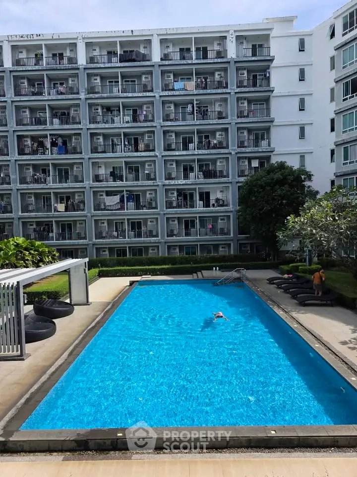 Modern apartment building with inviting swimming pool and lush greenery