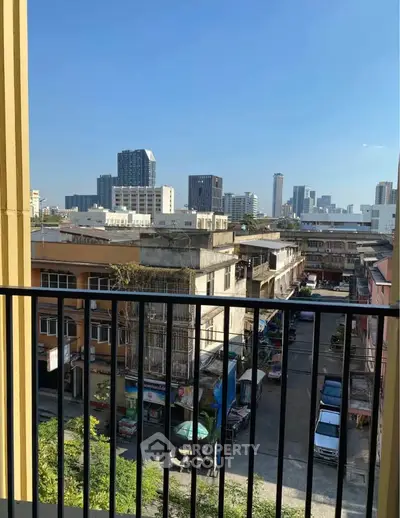 Stunning urban view from a balcony overlooking city skyline and residential area.