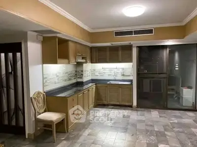 Spacious kitchen with modern design and ample storage in a stylish apartment.