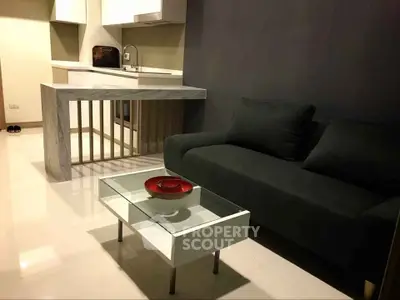 Modern living room with sleek kitchen and stylish furniture