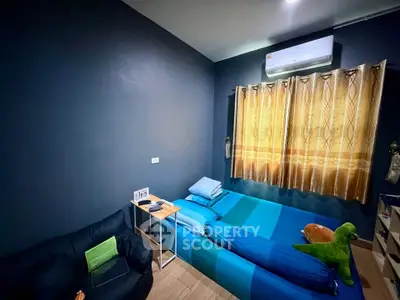 Cozy bedroom with modern decor and air conditioning, featuring a comfortable bed and stylish curtains.