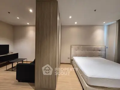 Modern studio apartment with cozy living area and elegant bedroom design.